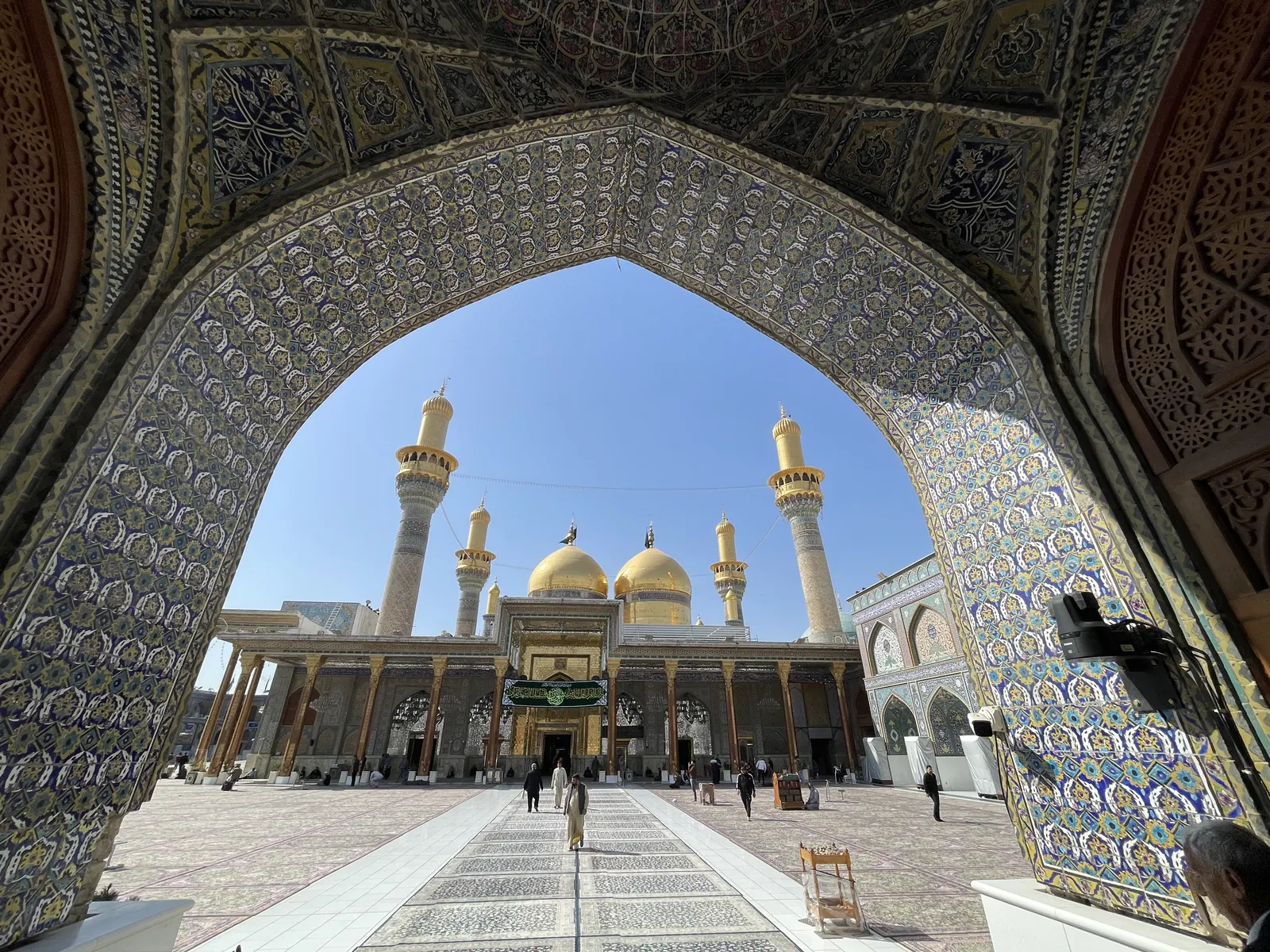 Kadhimiya shrine framed by a tiled archway