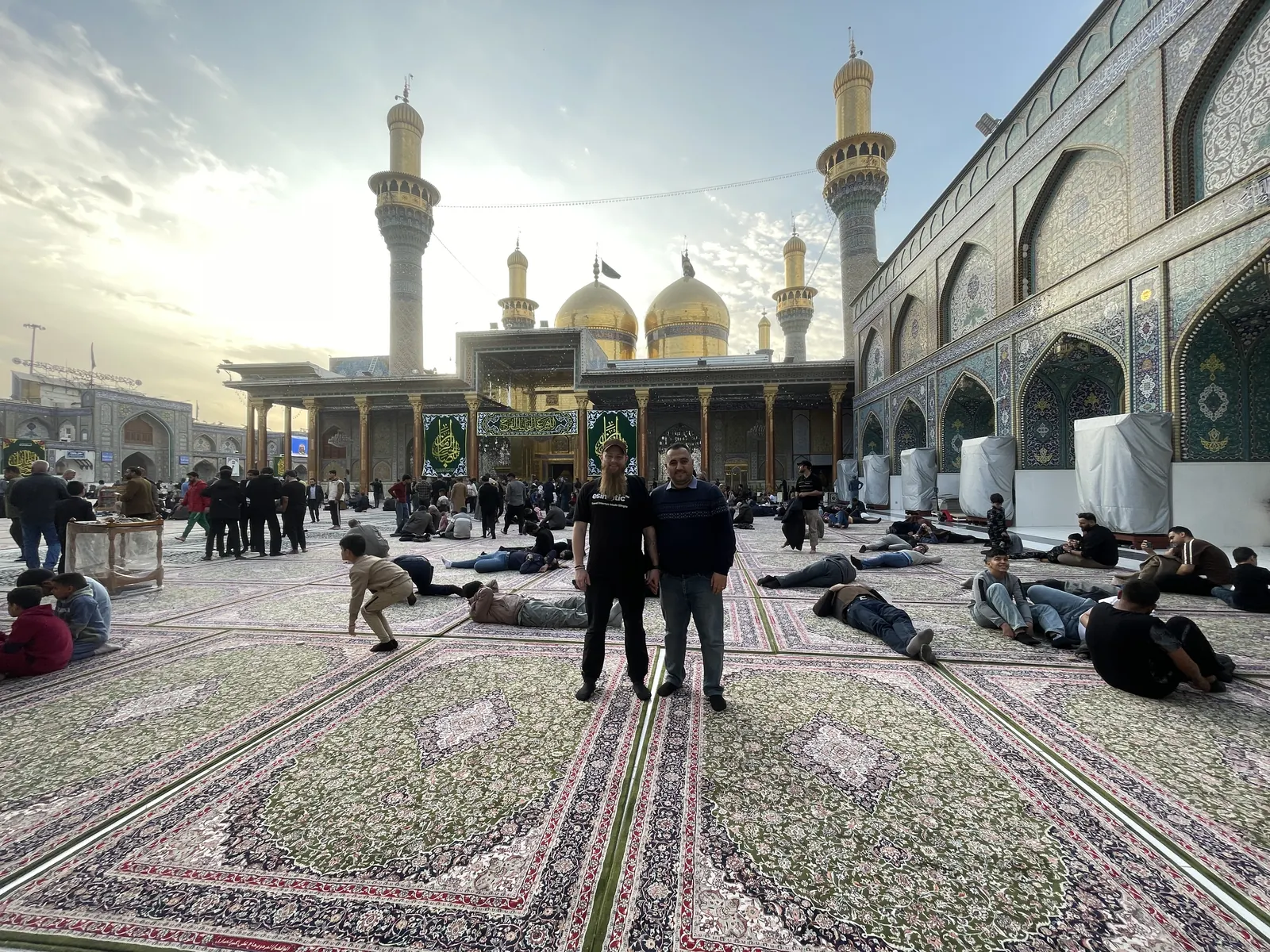 Kadhimiya shrine courtyard carpets at sunset